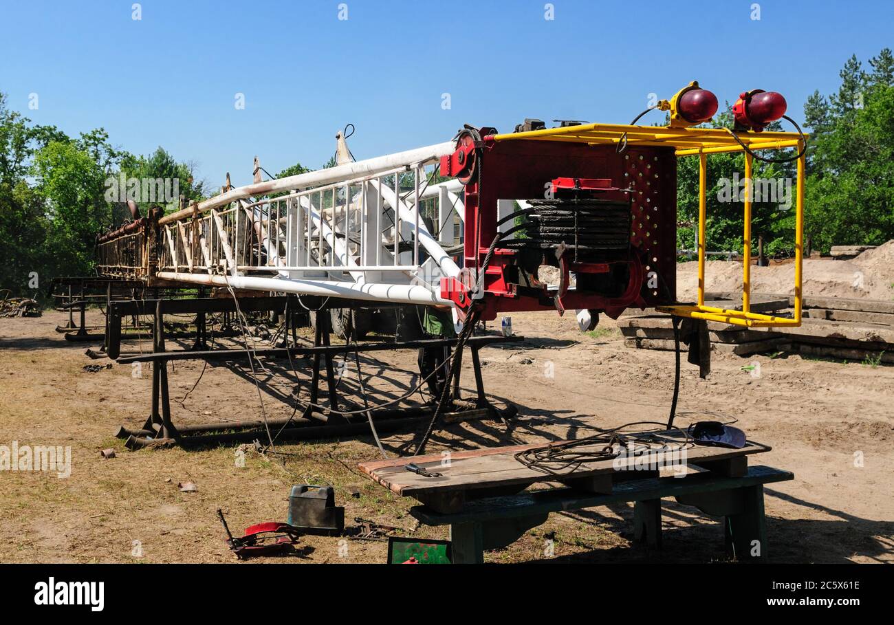 Painting and maintenance of the dismantled mast of the workover rig Stock Photo