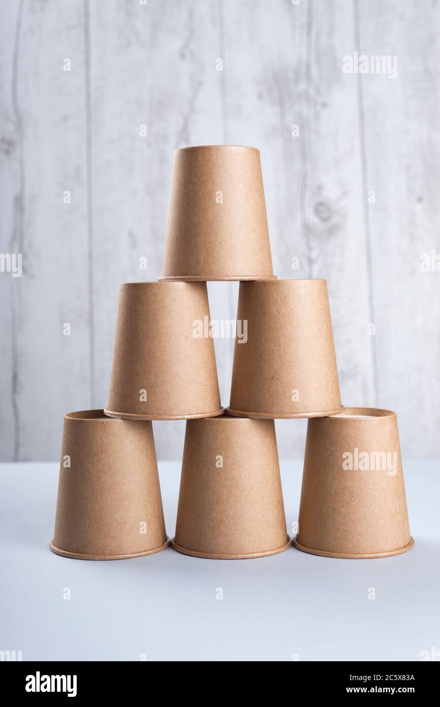 Coffee cups pyramid isolated on light background Stock Photo