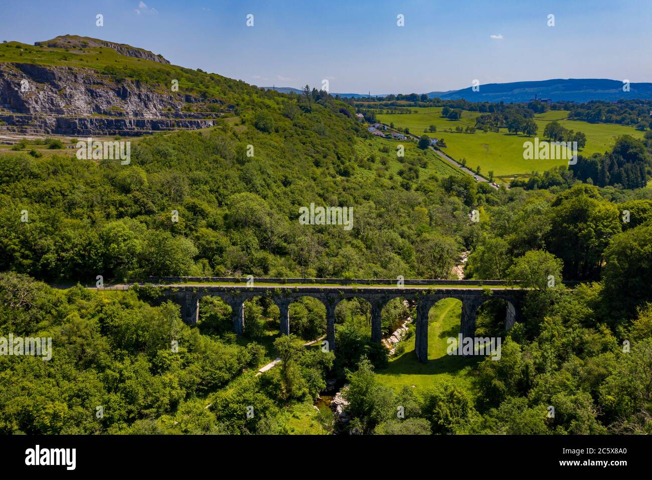 Aerial drone view of a Victorian era viaduct in a beautiful green valley (Pontsarn Viaduct, Brecon Beacons, Wales) Stock Photo