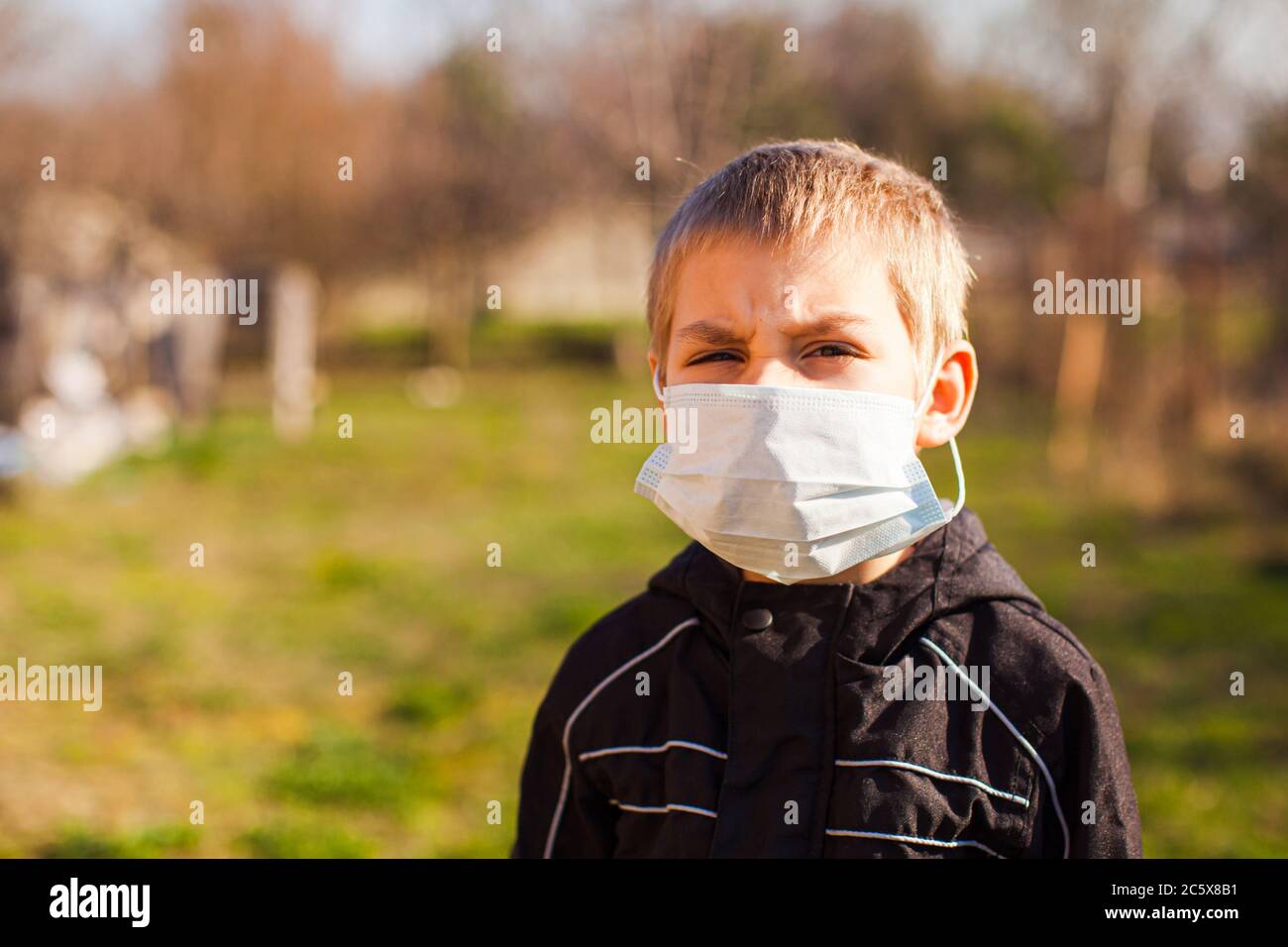 Boy wearing medical mask outdoors. Protection concept Stock Photo - Alamy