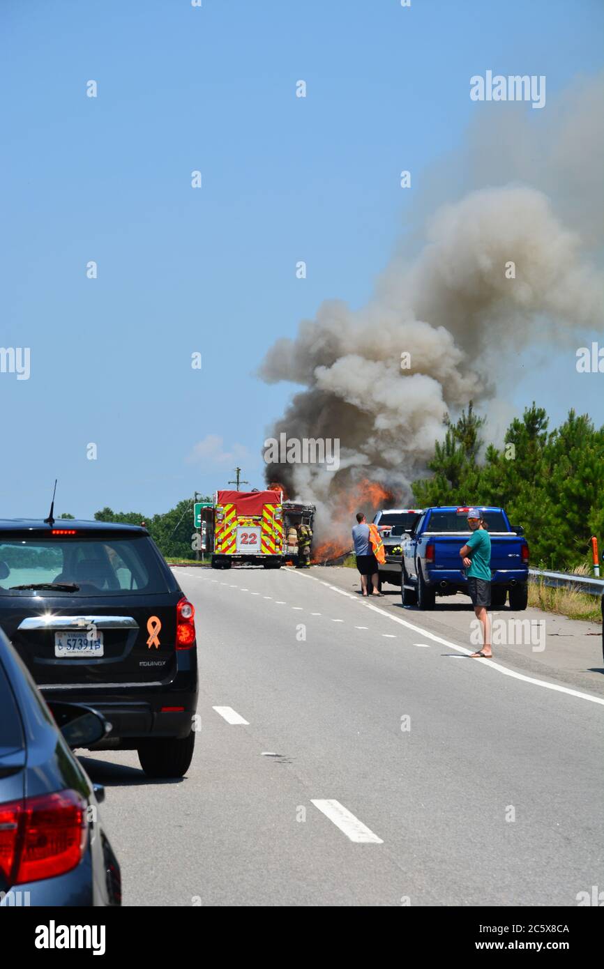 Smoke rises from a vehicle fire on Highway 64 outside of Williamston North Carolina. Stock Photo