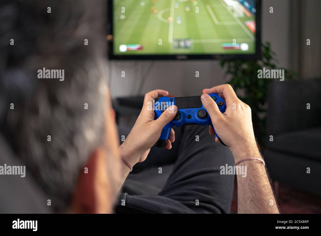 Gamer using controller to play online video games on computer. Man playing  game with joystick and headphones in front of monitor. Player having gaming  equipment, doing fun activity Stock Photo - Alamy