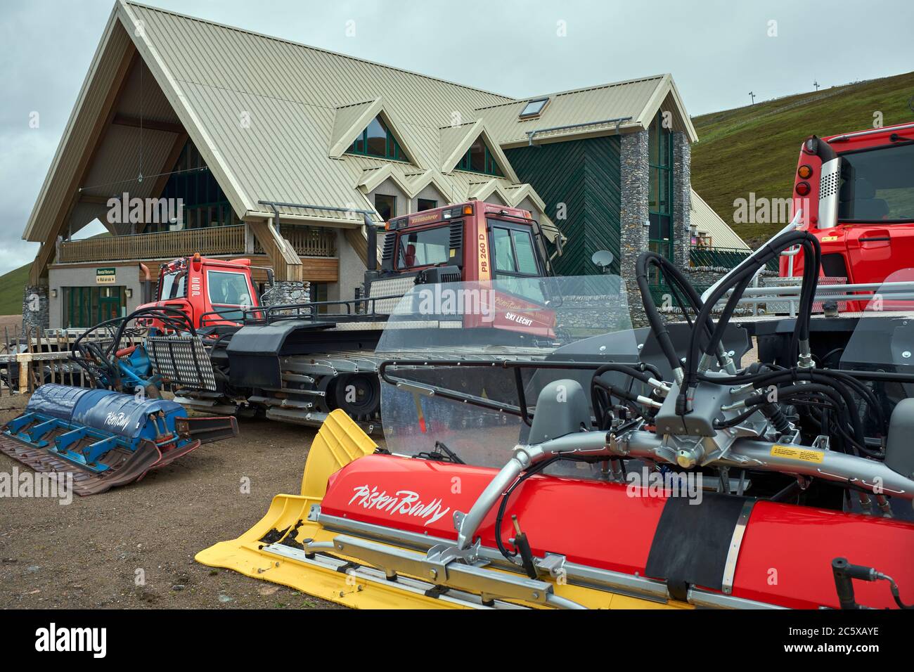 In a wet and gloomy July, Snow cats wait to get into action at the Lecht Ski Centre Stock Photo