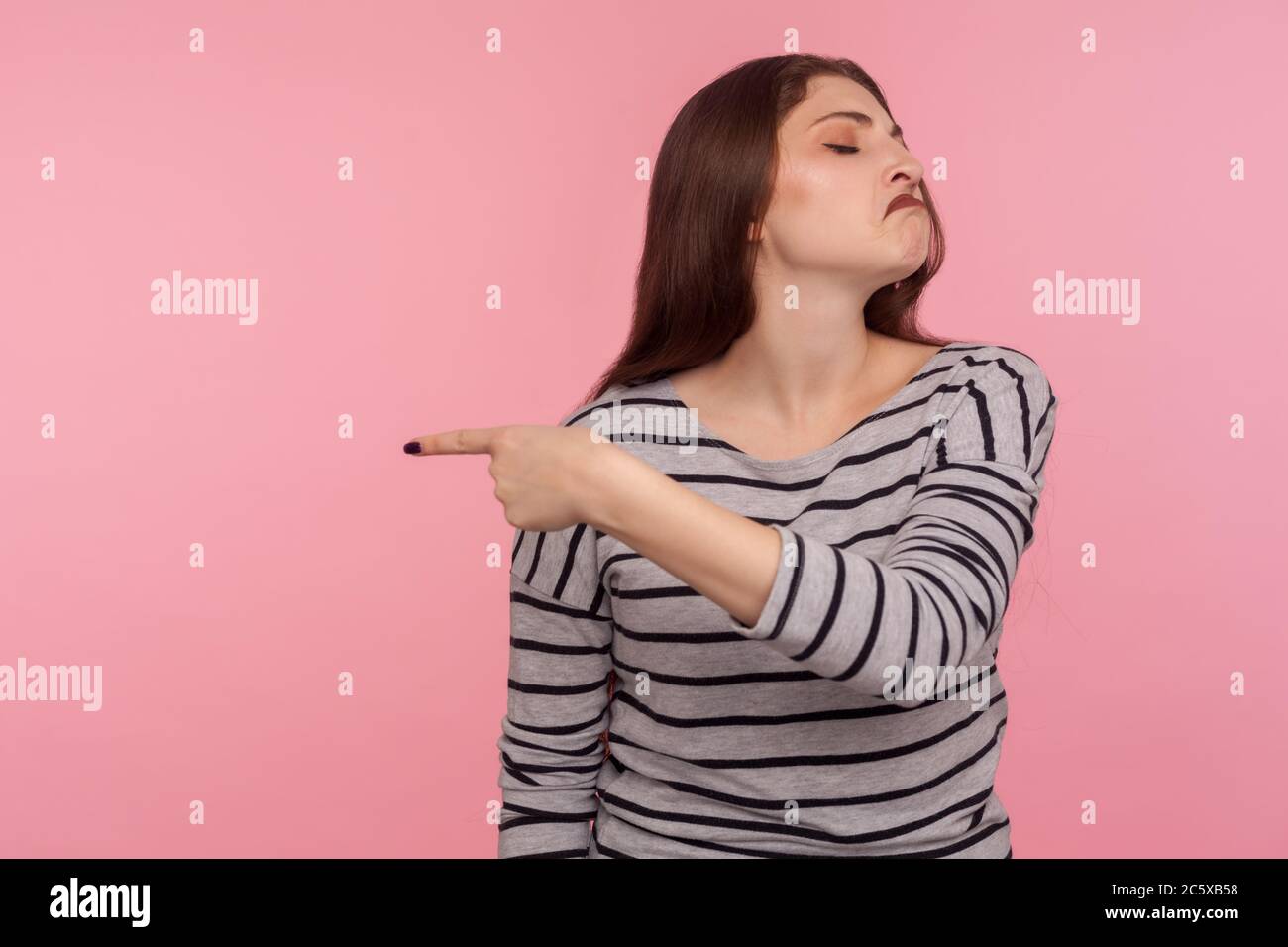 Get out! Portrait of vexed angry woman in striped sweatshirt grimacing madly and ordering to go away, feeling betrayed resentful, break up concept. in Stock Photo
