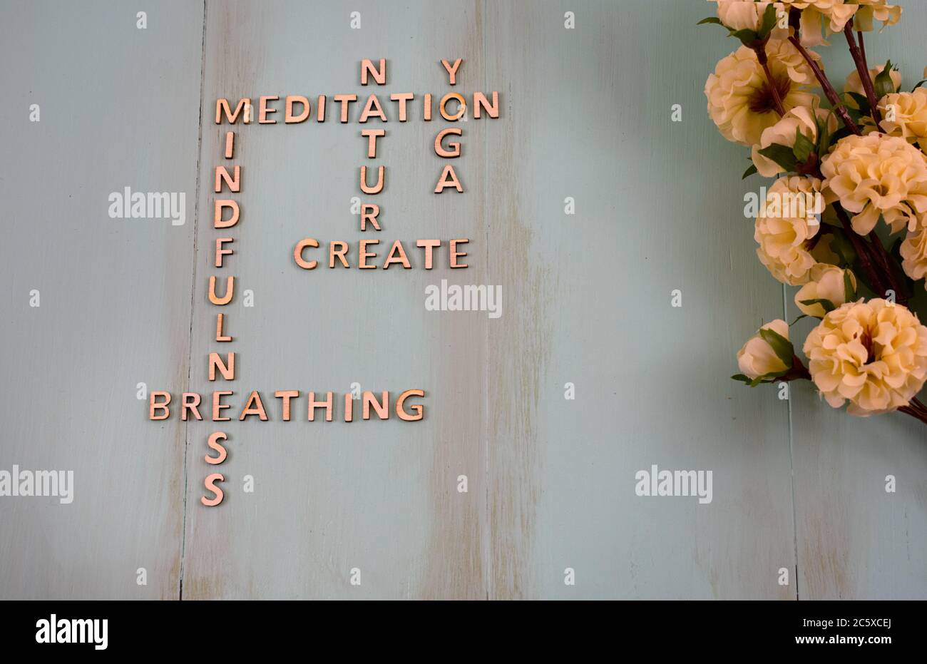 Wooden crosswords showing mental health support and coping strategies, meditation, nature, yoga creativity, mindfulness, breathing concept with copy s Stock Photo