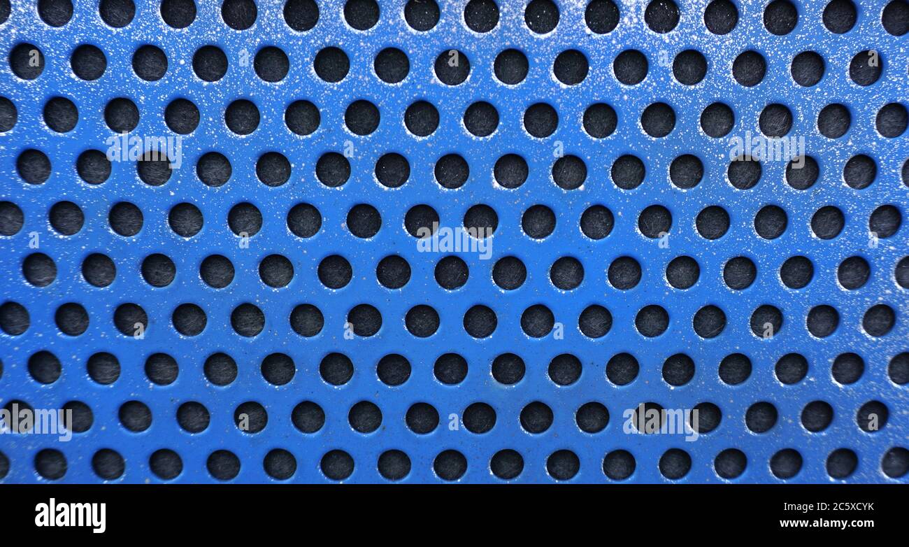 Blue metal background with black holes, metal mesh Stock Photo