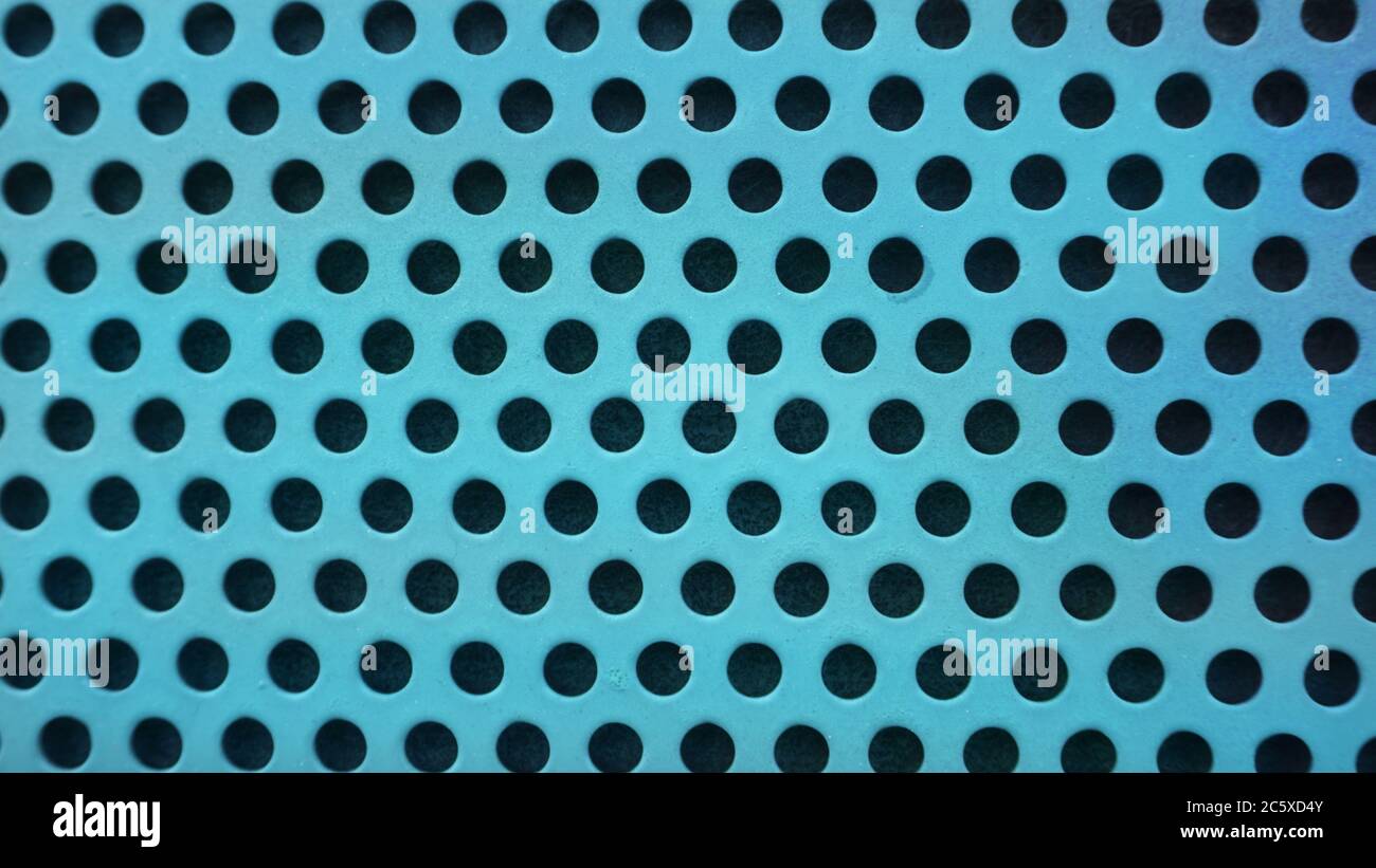 Blue, turquoise metal background with black holes, metal mesh Stock Photo