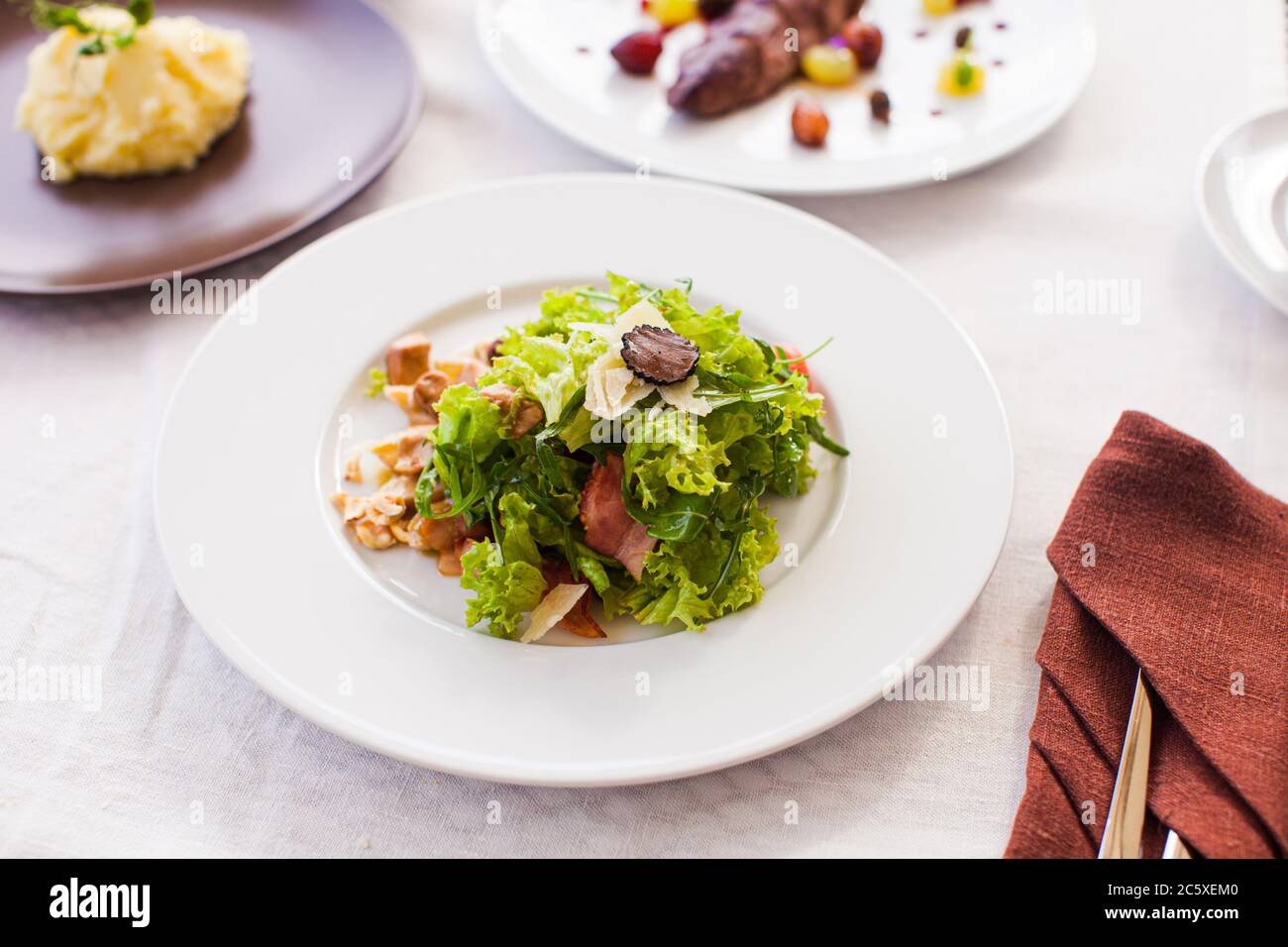 Appetizer with green salad leaves and prosciutto Stock Photo