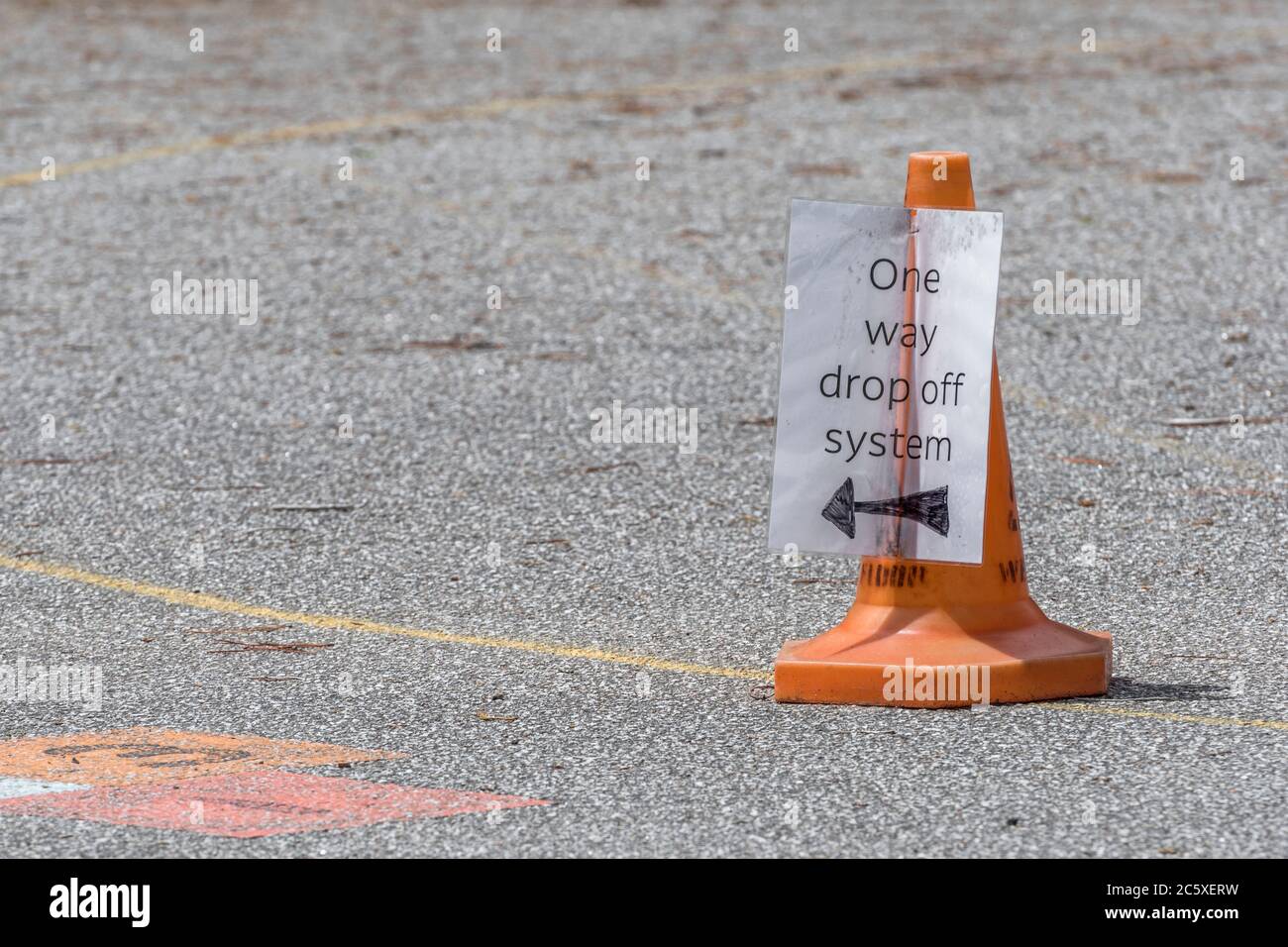 School safety measures for pick up and collection of pupils at St. Winnow Primary School, Lostwithiel. Covid-19 School Run safety concept. Stock Photo