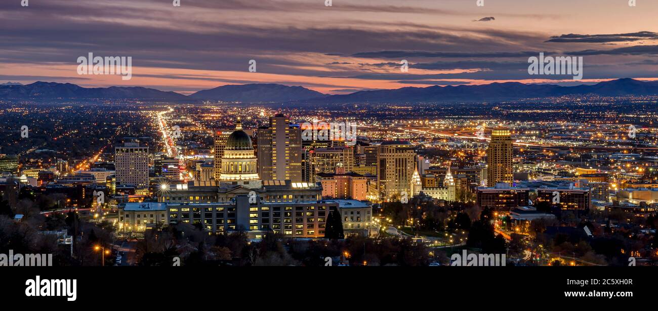 Salt Lake City is the capital of the state of Utah. The photo shows a skyline illuminated evening view. Stock Photo