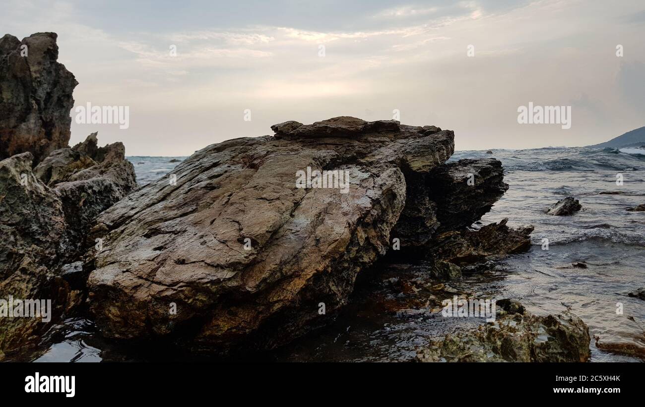 Huge sea rock on the coast Stock Photo