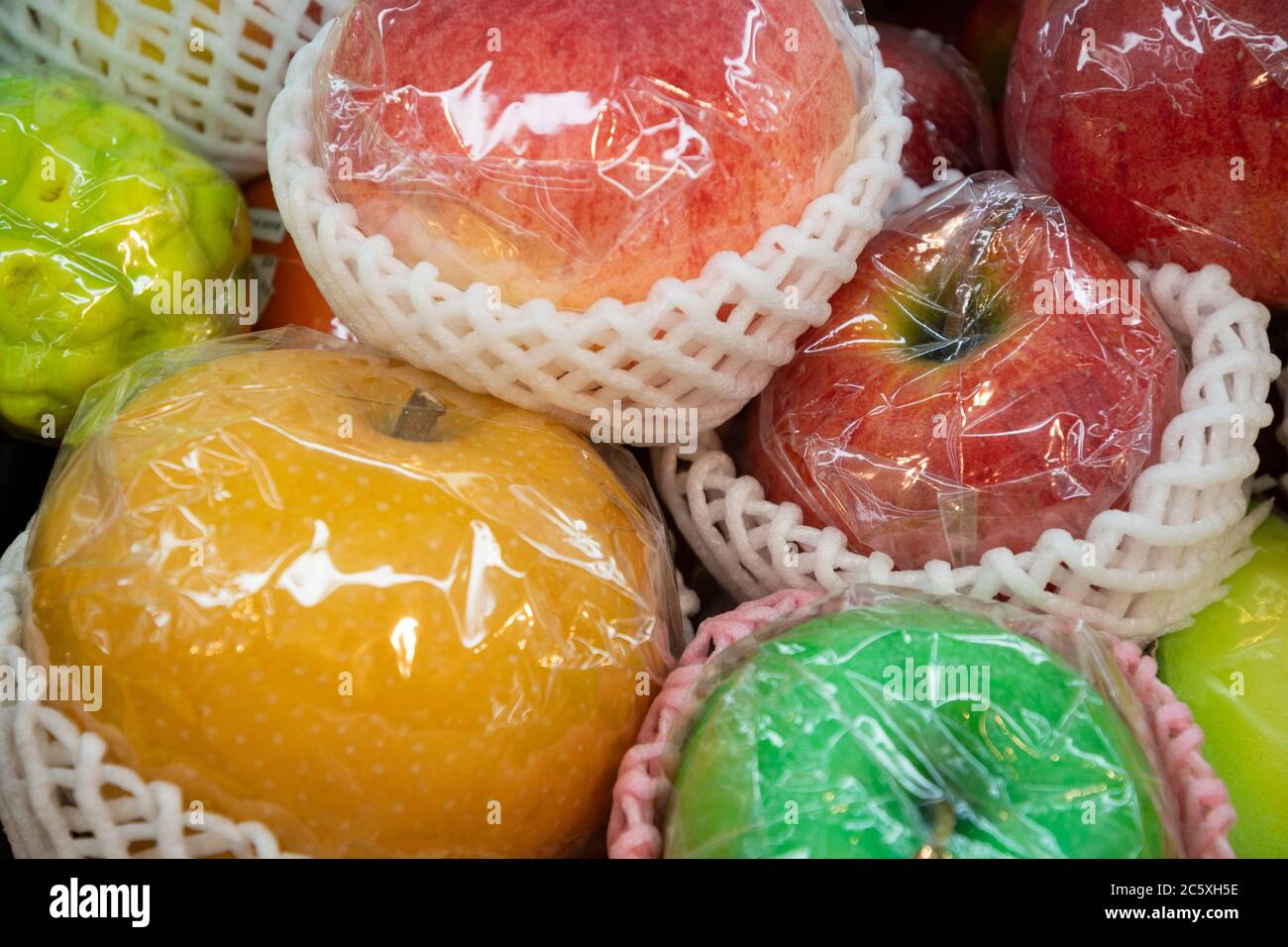 Close-up on packaged fruits (apples, mapo). Artificial food made by wax. Shop window display, restaurant menu food sample. Kappabashi dori, Tokyo. Stock Photo