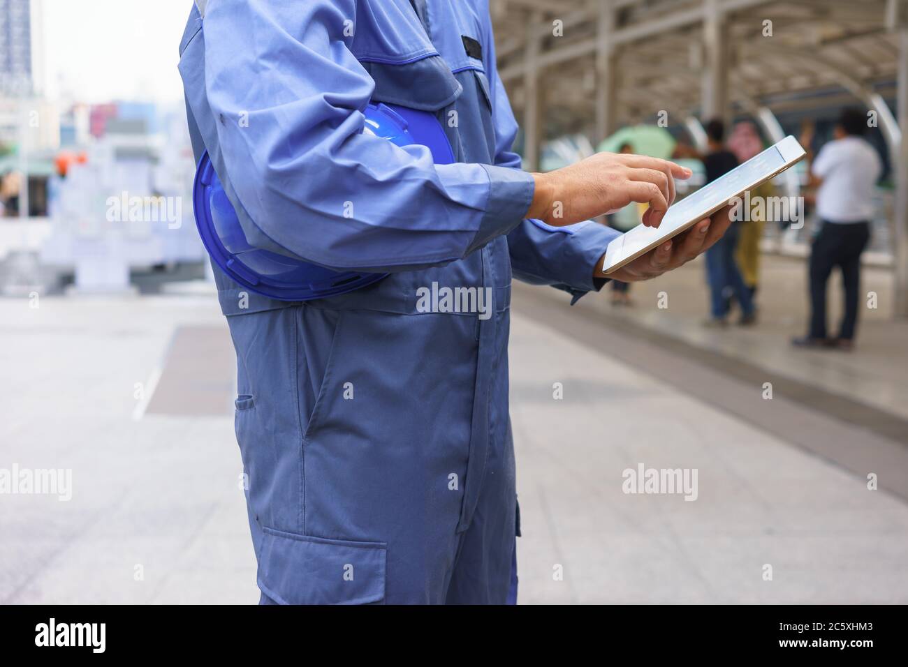 Mechanic is using a tablet. Stock Photo
