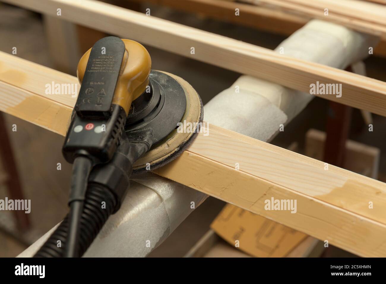 carpenter sanding wooden window in  workshop, close up Stock Photo