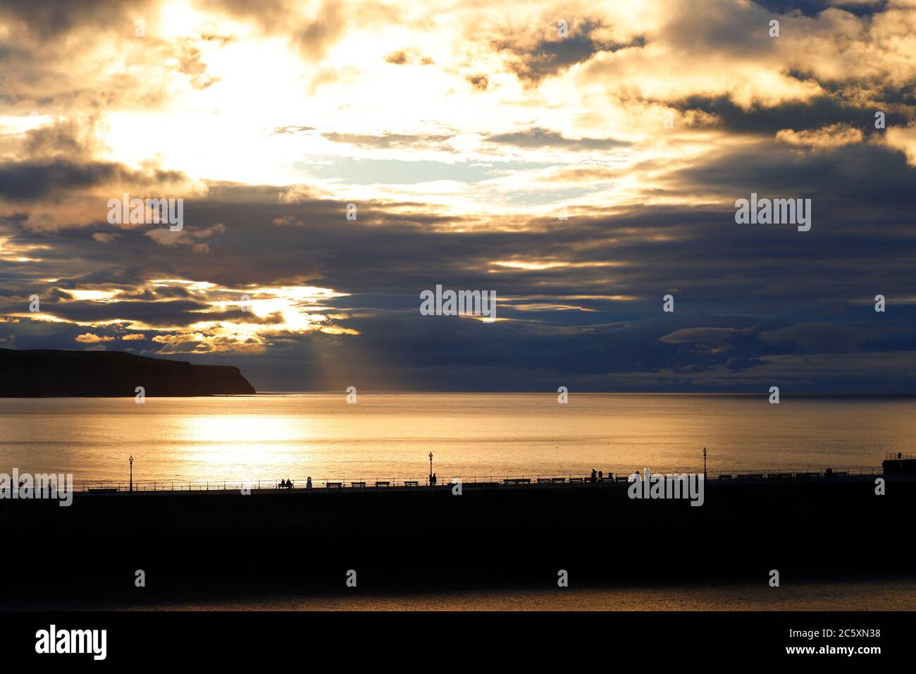 Whitby Sun The sun begins to set behind a cloudy sky in Whitby,North Yorkshire ...