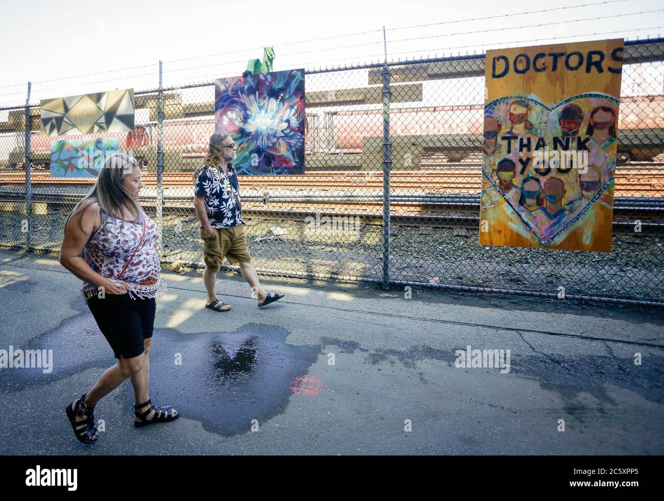 Vancouver, Canada. 5th July, 2020. People visit the Murals of Gratitude Exhibition at Gastown in Vancouver, British Columbia, Canada, July 5, 2020. The exhibition showcased 35 murals completed by more than 20 artists to honour the frontline health workers fighting against the COVID-19 pandemic. Credit: Liang Sen/Xinhua/Alamy Live News Stock Photo