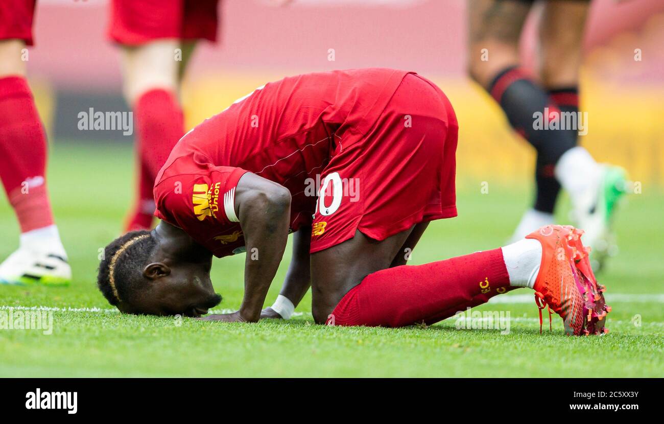 Liverpool. 6th July, 2020. Liverpool's Sadio Mane kneels to celebrates after scoring the Premier League match between Liverpool and Aston Villa at Anfield in Liverpool, Britain on July 5, 2020.FOR EDITORIAL USE ONLY. NOT FOR SALE FOR MARKETING OR ADVERTISING CAMPAIGNS. NO USE WITH UNAUTHORIZED AUDIO, VIDEO, DATA, FIXTURE LISTS, CLUB/LEAGUE LOGOS OR "LIVE" SERVICES. ONLINE IN-MATCH USE LIMITED TO 45 IMAGES, NO VIDEO EMULATION. NO USE IN BETTING, GAMES OR SINGLE CLUB/LEAGUE/PLAYER PUBLICATIONS. Credit: Xinhua/Alamy Live News Stock Photo