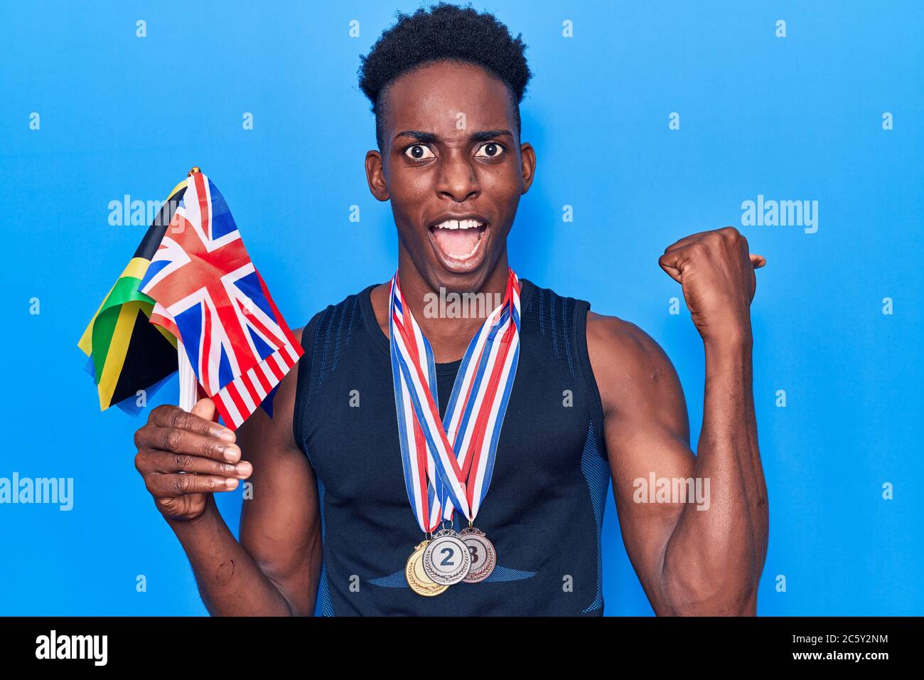 Young african american man wearing medals holding jamaica, usa and uk ...