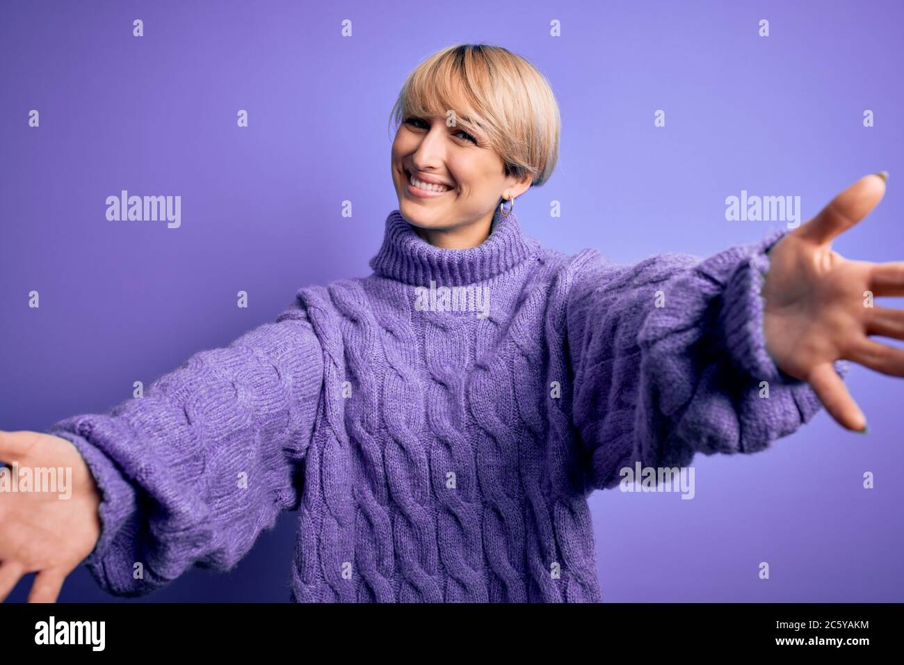 Young blonde woman with short hair wearing winter turtleneck sweater ...
