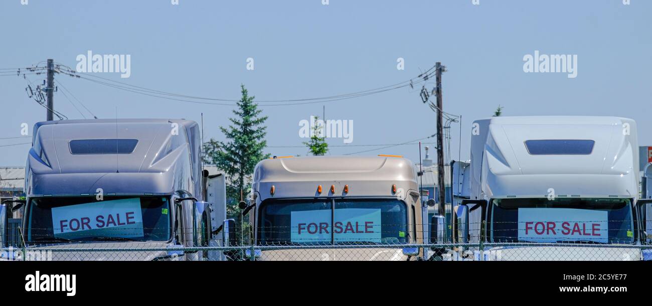 Trucks for sale at a dealership in industrial area Stock Photo