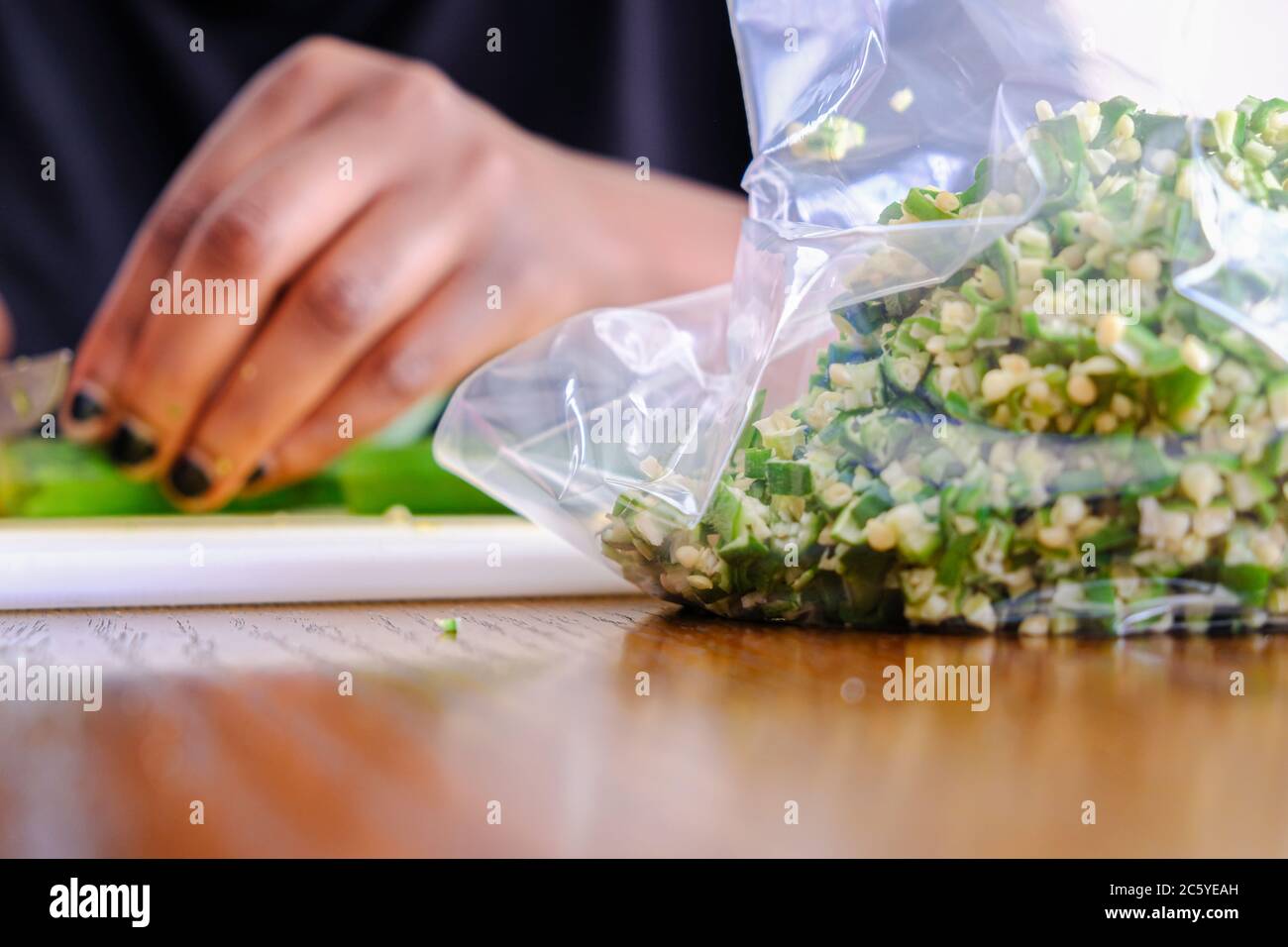 Woman Preparing Nigerian Okra Okra for storage in a fridge Stock Photo