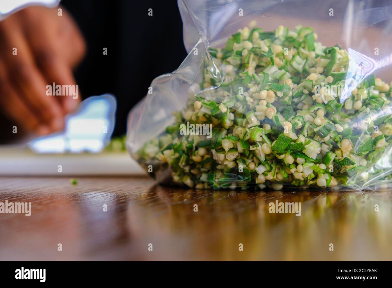 Woman Preparing Nigerian Okra Okra for storage in a fridge Stock Photo