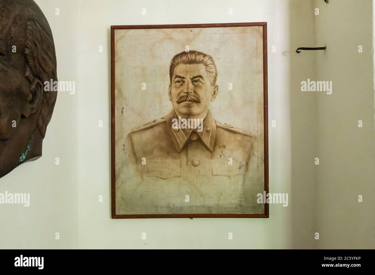 A drawing of Stalin hangs in the former prison building used by the German Nazis during WWII as a concentration camp headquarters. In Macikai, Lithuan Stock Photo