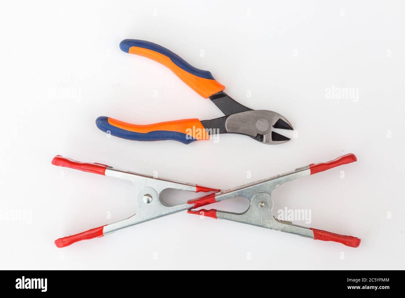 Side cutters and two A-clamps on white background. Stock Photo