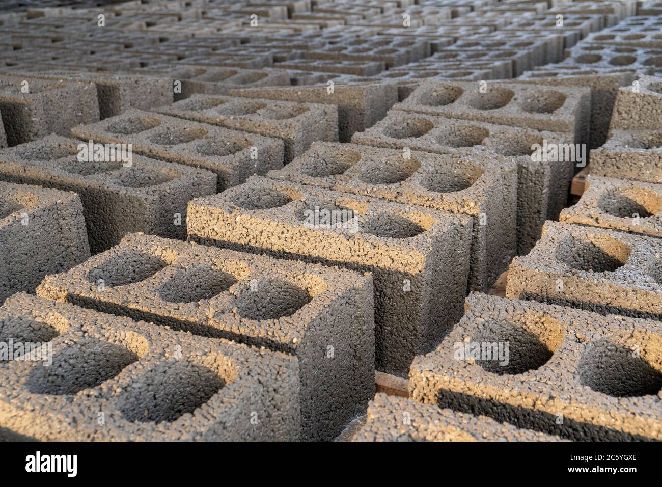 stacks of gray concrete blocks on the ground Stock Photo