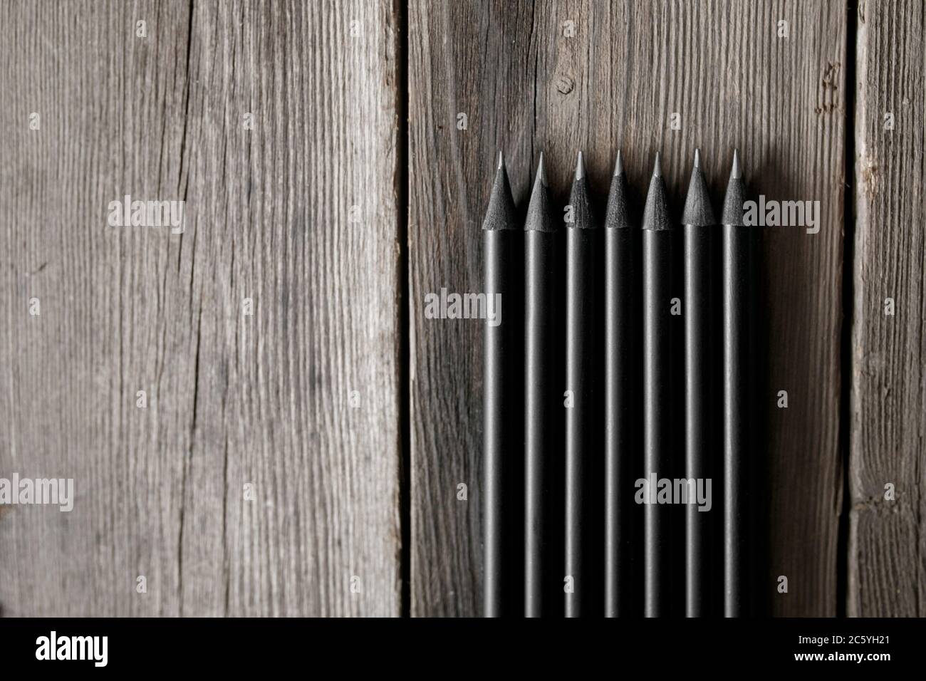 Sharp graphite pencils on wooden background, closeup Stock Photo