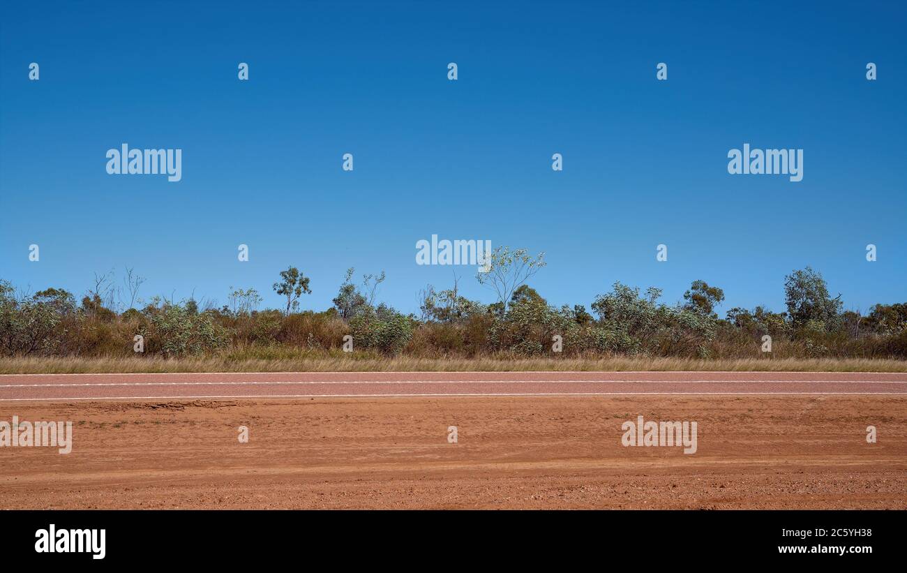 The dry grass plains and spaciousness of the Australian outback under a