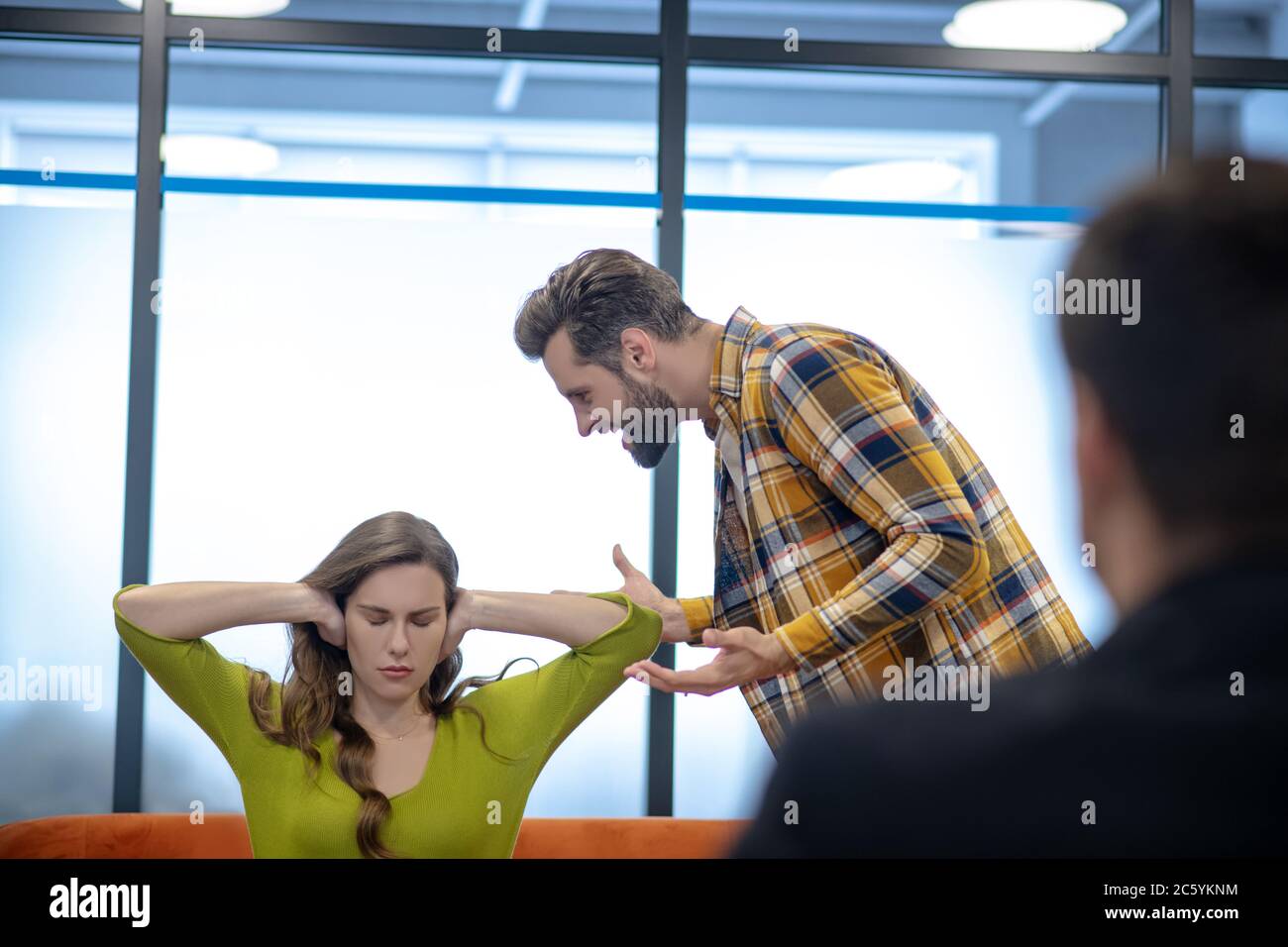 Young man angrily yelling at his wife Stock Photo