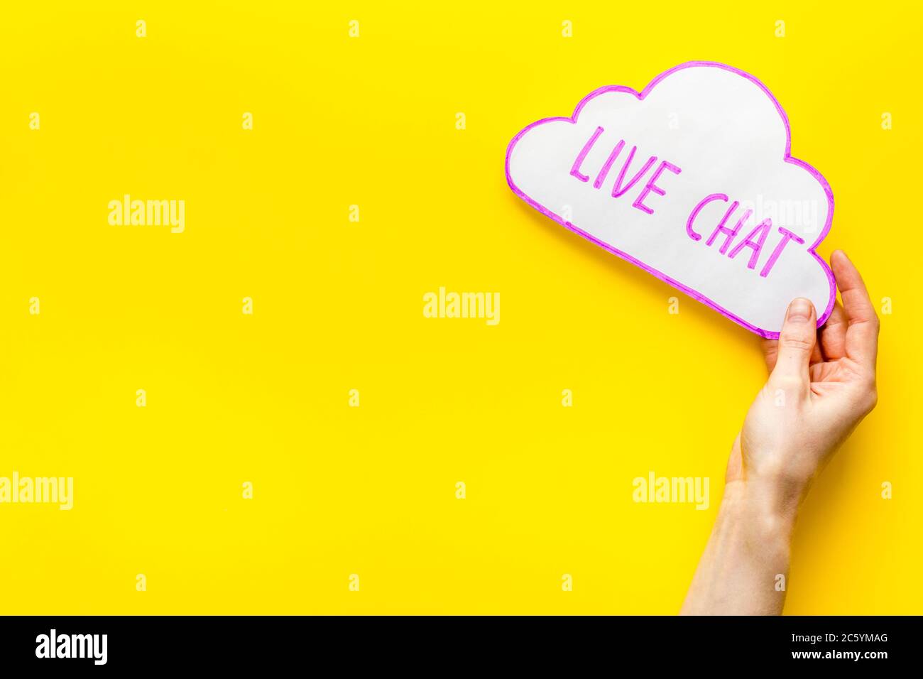 Live chat concept - bubble in hands on yellow table top view Stock Photo -  Alamy