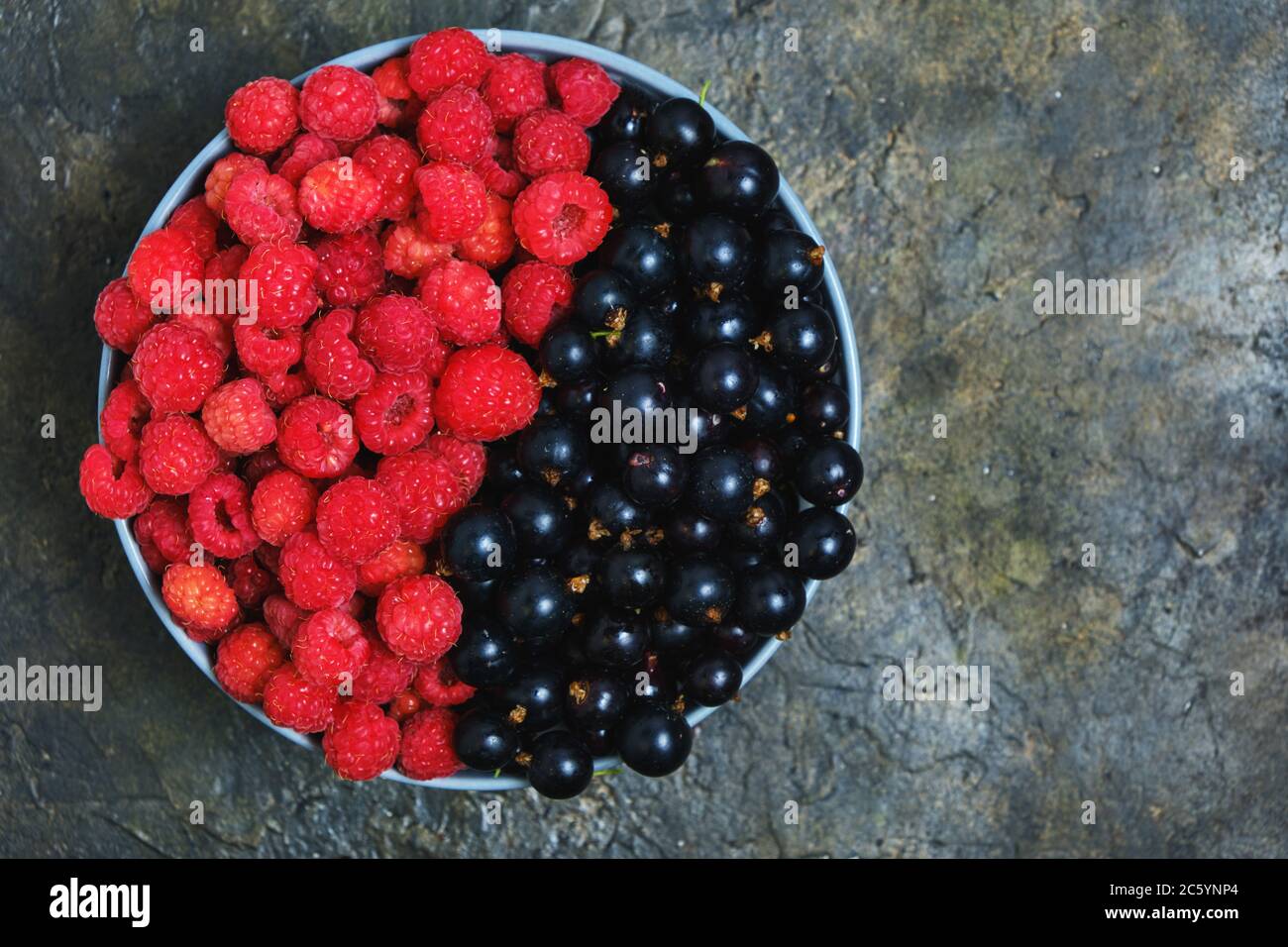 Raspberry and blackcurrant berries in a Cup view from the top Stock ...
