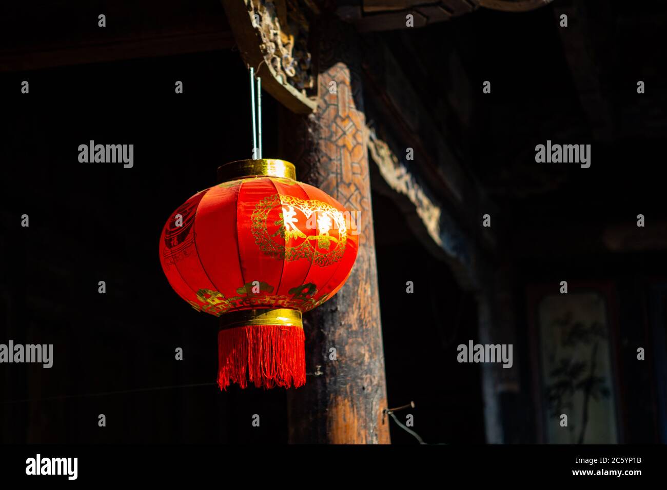 A Chinese red lantern hanging on the corner of a wall Stock Photo - Alamy
