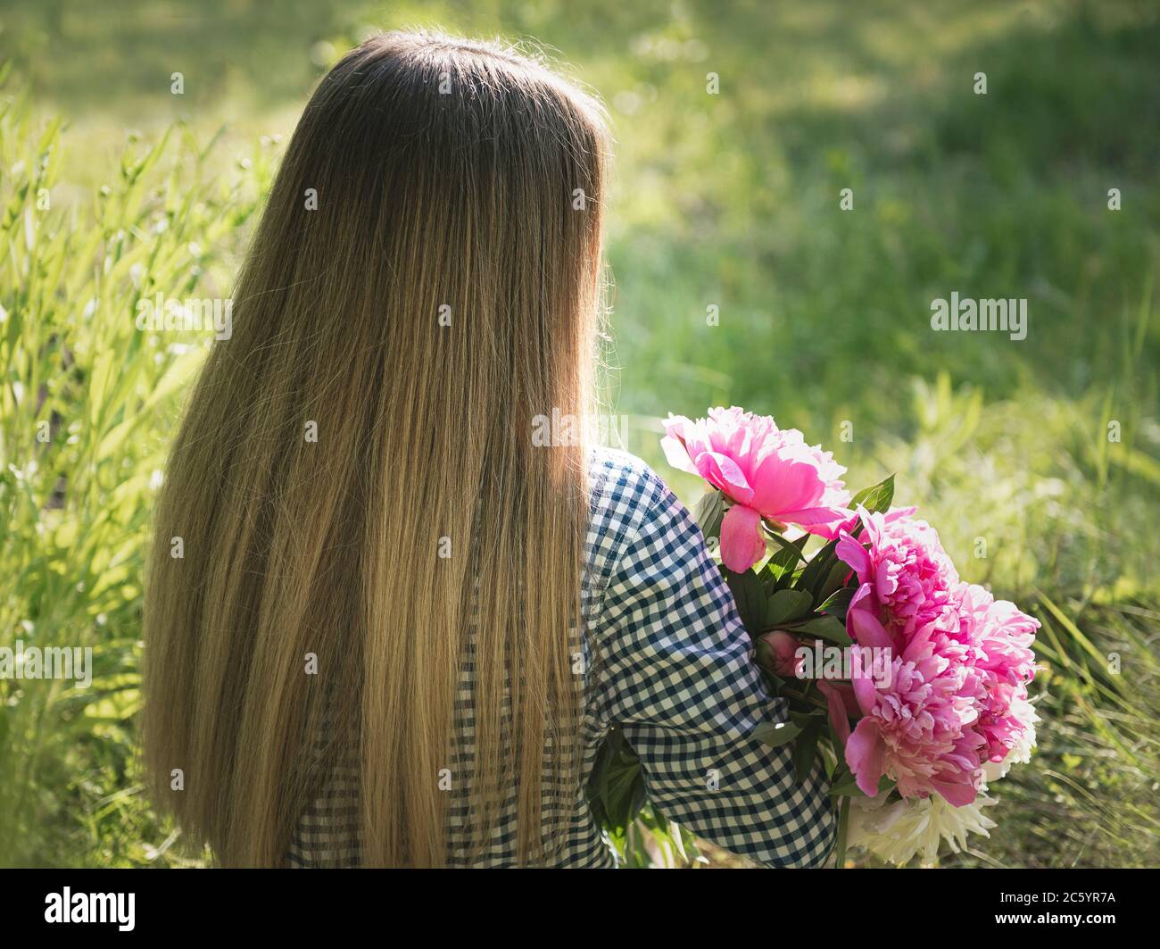 Portrait of a beautiful girl with a bouquet of peonies Stock Photo - Alamy