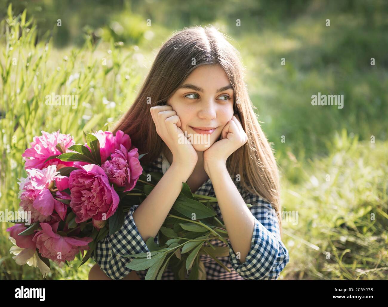 Portrait of a beautiful girl with a bouquet of peonies Stock Photo - Alamy