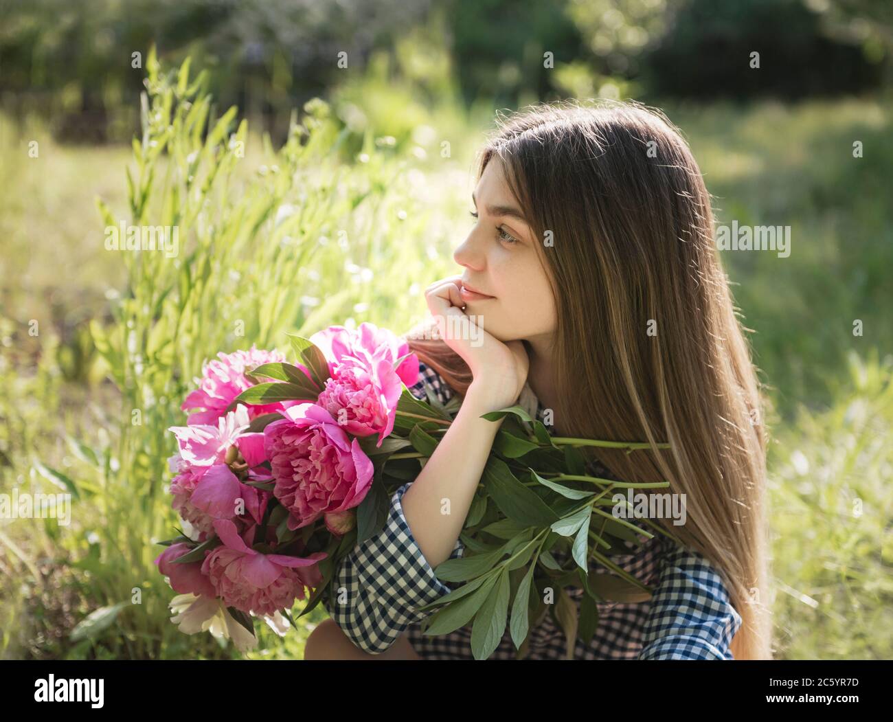 Portrait of a beautiful girl with a bouquet of peonies Stock Photo - Alamy