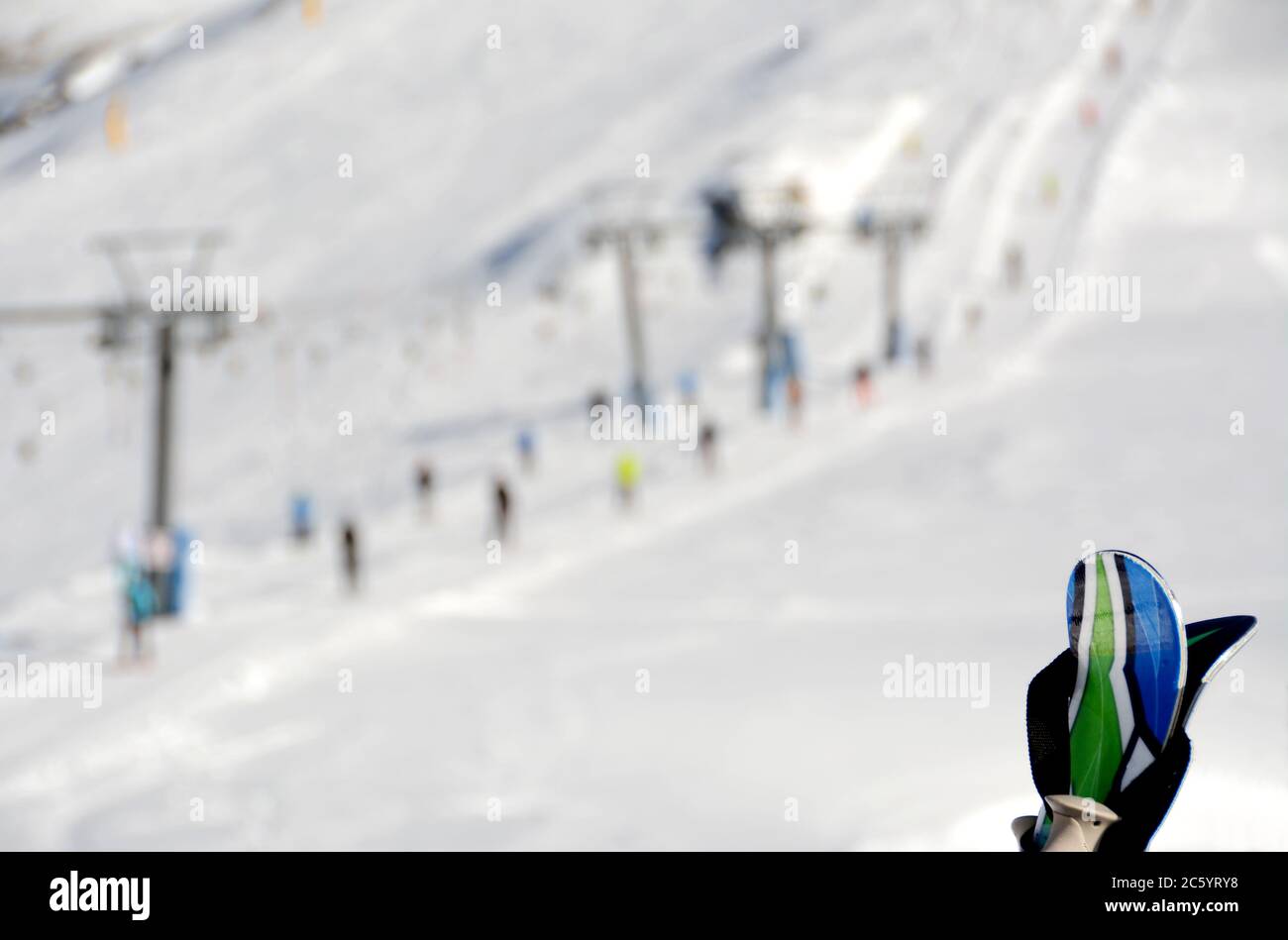 ski equipment on blurred background of skiers, snow, slopes, ski lift
