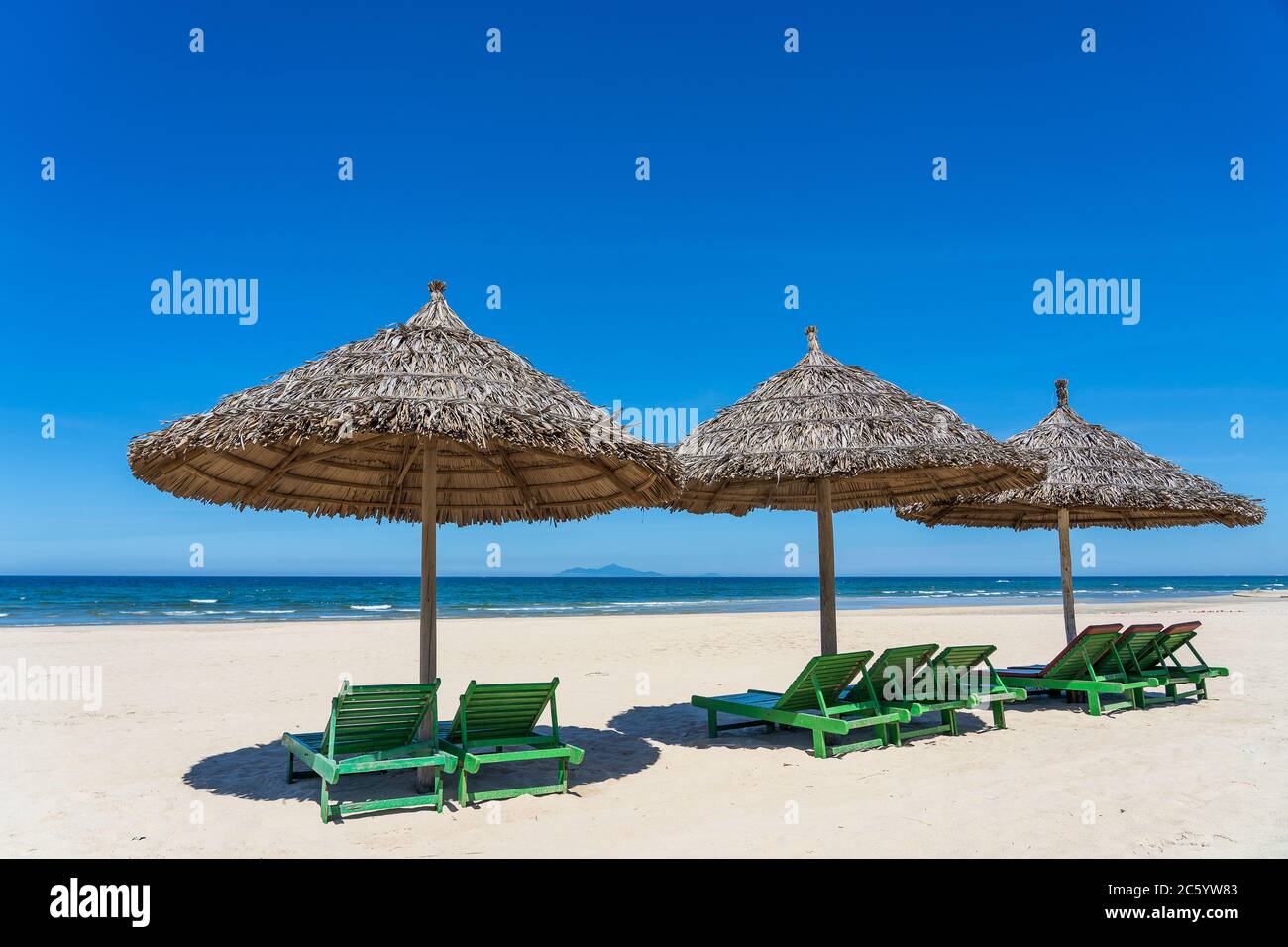 Tropical Sand Beach And Summer Sea Water With Blue Sky And Three Straw Umbrella In Danang City Vietnam Travel And Nature Concept Stock Photo Alamy
