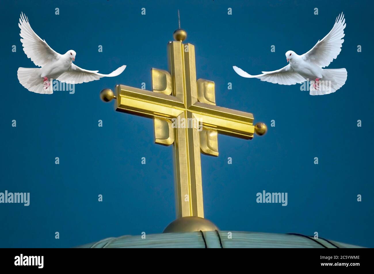 two white doves in flight around the golden cross on the dome of the temple Stock Photo