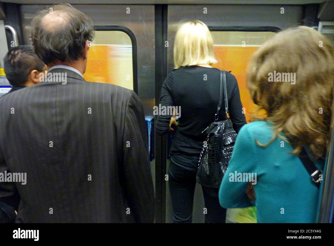 People waiting to exit at their station. Stock Photo