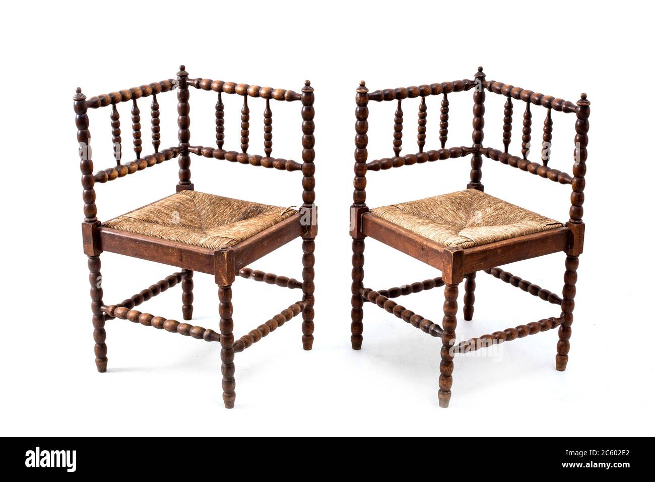 Pair of old fashioned wood armchairs on the white background. Stock Photo