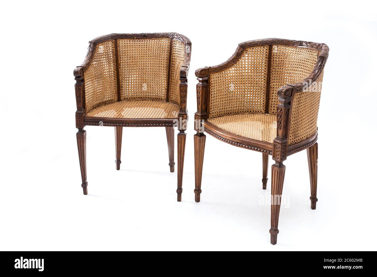 Pair of old fashioned wood armchairs on the white background. Stock Photo