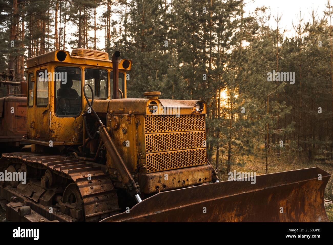 Old rusty tractor in countryside in woods Stock Photo - Alamy