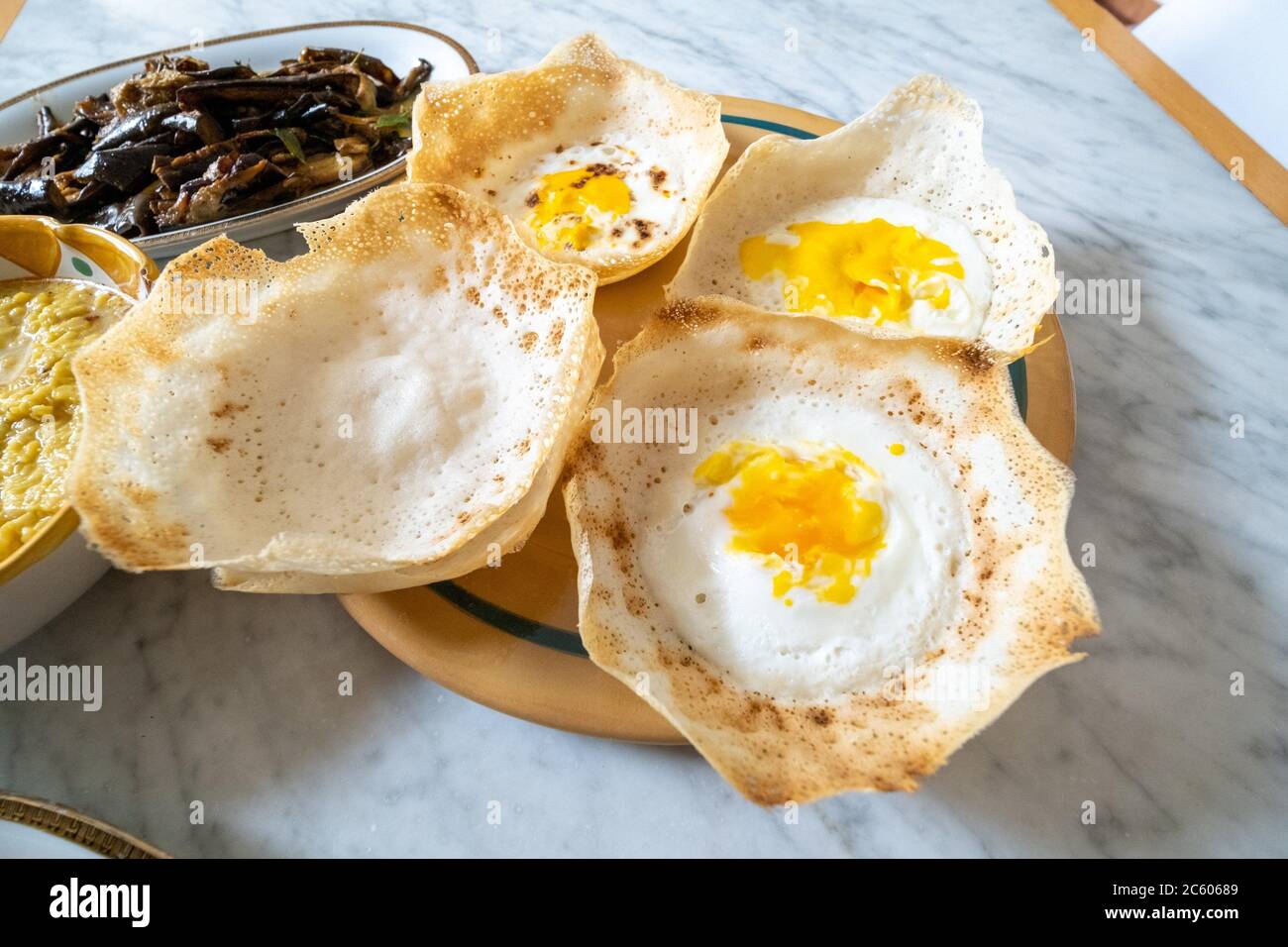 Homemade srilankan dishes, egg hopper,samosas and eggplantts with sugar