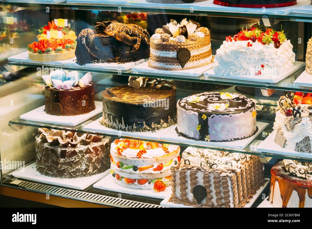 Various Different Types Of Sweet Cakes In Pastry Shop Glass Display