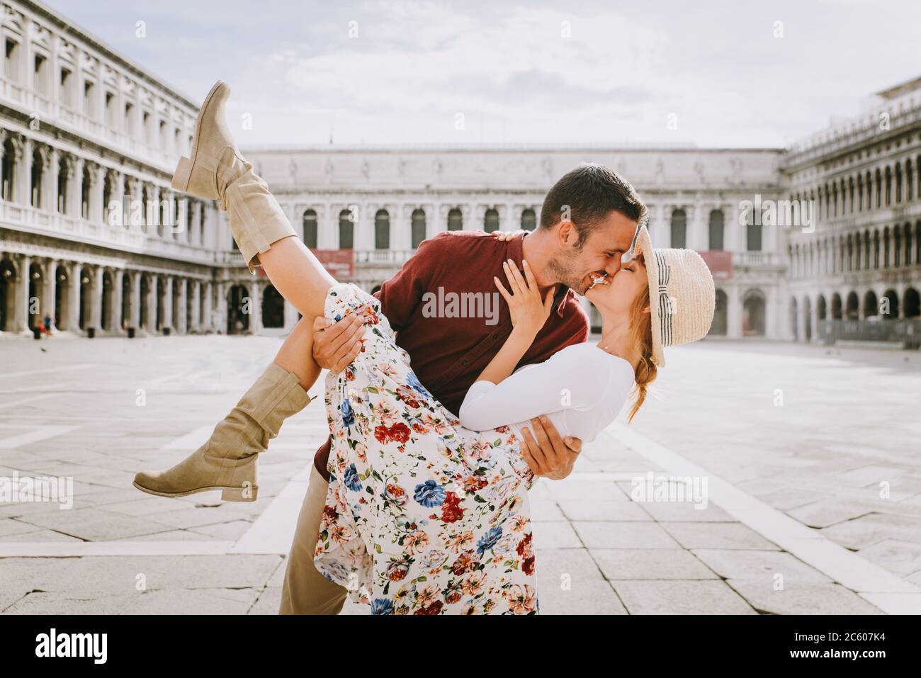 Beatiful young couple having fun while visiting Venice Tourists