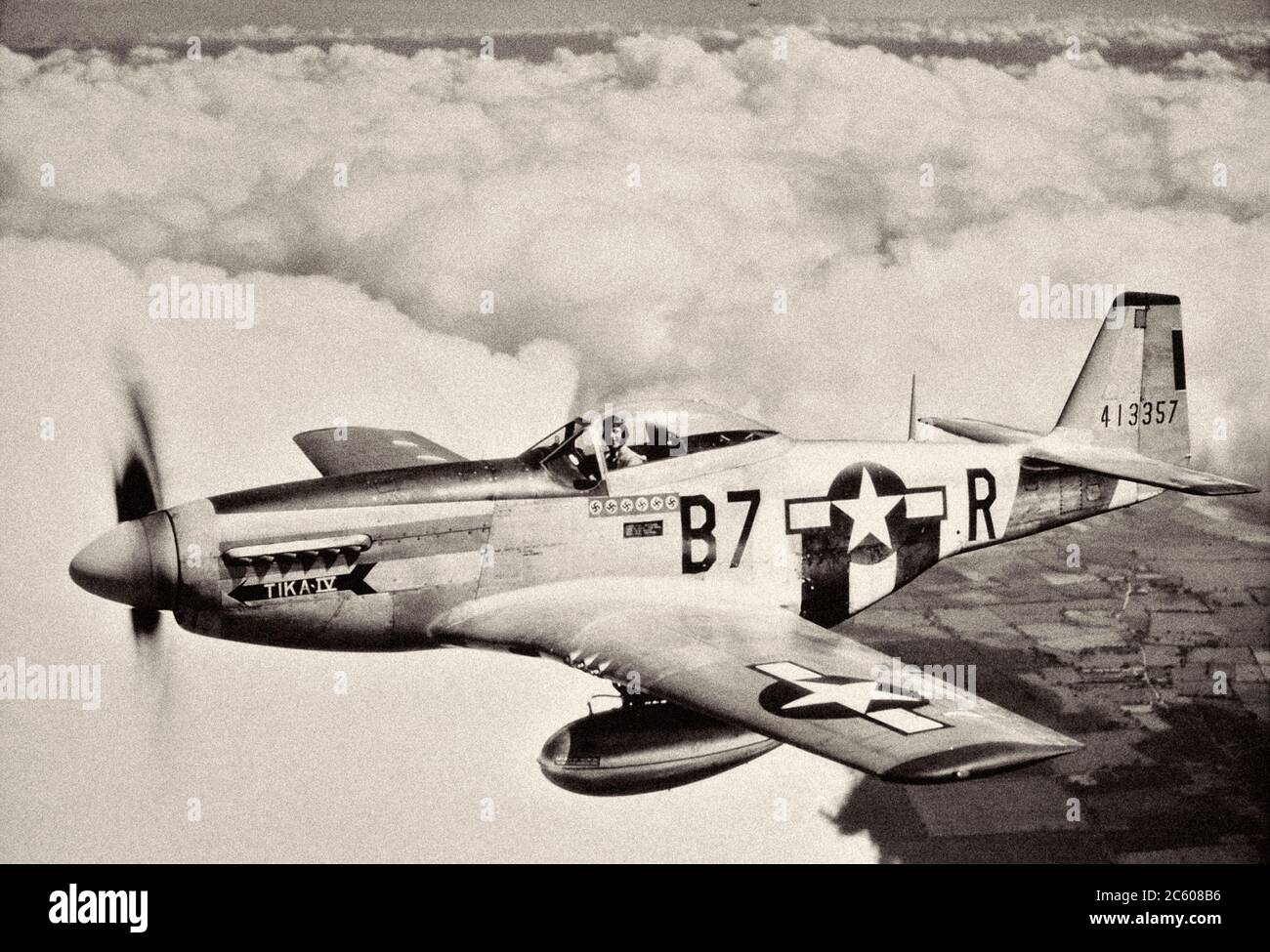 Lieutenant Vernon Richards of the 361st Fighter Group pilots his P-51D Mustang, nicknamed ‘Tika IV’, during a bomber escort mission. 1944 Stock Photo