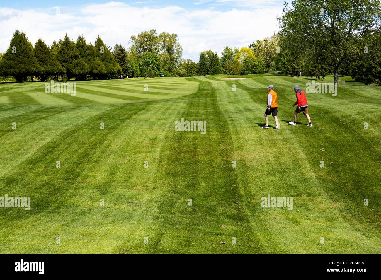 People walk on a golf course in Vancouver, BC, Canada during the covid-19 epidemic. Stock Photo